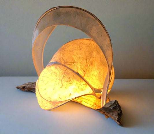 Decorative lamp with a warm glow on a wooden surface